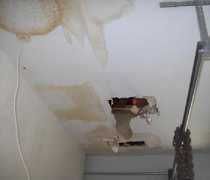 A leaky roof with paint filled with water.